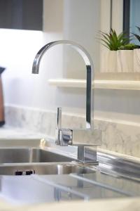 a sink with a faucet in a kitchen at Exclusive 8beds 2bath Luxury Contractors Delight! in Southampton