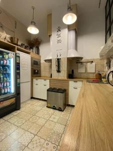 a kitchen with a counter and a refrigerator in it at Hostel Numero Trece in Alicante
