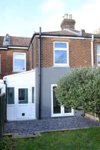 a house with white doors and a brick building at Exclusive 8beds 2bath Luxury Contractors Delight! in Southampton