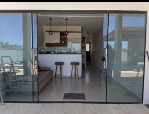 a kitchen and living room with sliding glass doors at Casa beach Japaratinga in Japaratinga