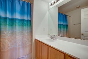 a bathroom with a sink and a mirror at Bright Greenbackville Vacation Home with Game Room in Greenbackville +25 photos