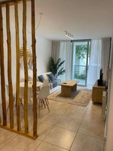 a bedroom with a bed and a living room at Antique Barraca in Concepción del Uruguay