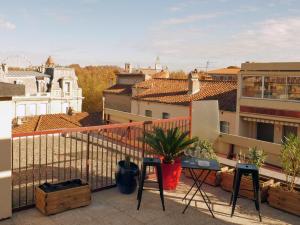 a balcony with a view of a city at Le Penthouse des Halles in Perpignan