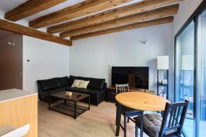 a living room with a black couch and a table at Apartamento Chapitela Deluxe in Pamplona