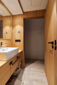 a bathroom with a white sink next to a door at Apartamento Chapitela Deluxe in Pamplona