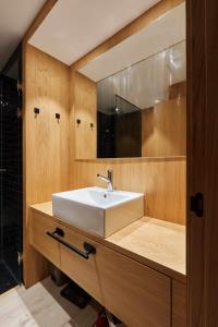 a bathroom with a white sink and a mirror at Apartamento Chapitela Deluxe in Pamplona