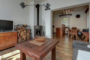 a living room with a wooden table and a fireplace at Chalupa EMA in Abertamy