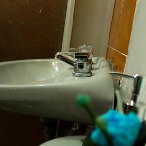 y baño con lavabo blanco y espejo. en Casa Mostaza, en Medellín
