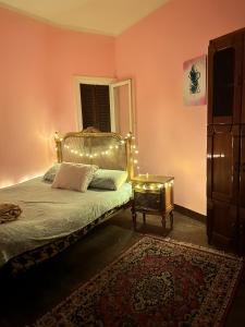 a bedroom with a bed with lights on it at Cozy room in the heart of cairo in Cairo