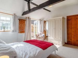 1 dormitorio con 1 cama, 1 silla y 1 ventana en 1 bed in Wroxham 87414 en Hainford