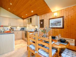 a kitchen and dining room with a table and chairs at 3 Bed in Ullswater 88212 in Tirril