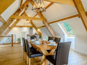 a dining room with a wooden table and black chairs at 3 Bed in Brecon 88249 in Brecon