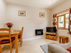 a living room with a table and a tv at 1 Bed in South Molton 89089 in South Molton