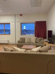 a living room with a couch and a tv at Trestads Värdshus in Vänersborg