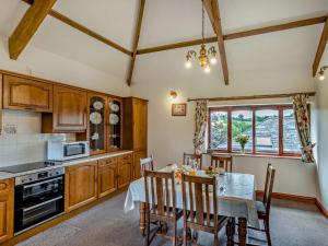 a kitchen with a table and a dining room at 3 bed property in Bude SHEPH in Merryfield
