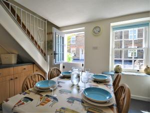 a dining room with a table and chairs and a clock at 2 Bed in Padstow KCOTT in Wadebridge