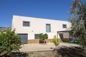 a white building with trees in front of it at RentitSpain - Alpujarra - Las Fanegas Tranquilidad al Pie de la Montaña in Yátor