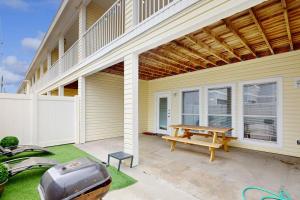 a patio with a picnic table and a grill at Beach Haven Unit 201 in Corpus Christi