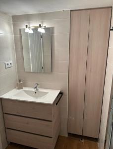 a bathroom with a sink and a mirror at CHECK-IN CASAS Casa Benas in Benasque