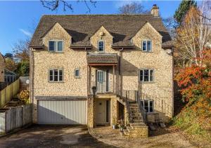 a large brick house with a garage at The Studio @ No. 6 in Brimscombe