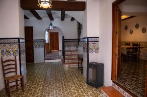 a living room with a hallway with a table at CASA LOLA Naturaleza, Montañas y Piscina Compartida De Pueblo in Carroja