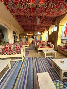 a room with couches and tables and a red ceiling at Elaria Hotel Hurgada in Hurghada