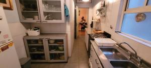 a small kitchen with a sink and a stove at Departamento acogedor recoleta in Buenos Aires