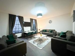 a living room with couches and a table at Mulberry Aparthotel in Newcastle upon Tyne