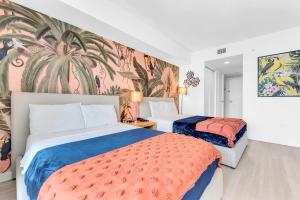 a hotel room with two beds and a mural at Water View Building With Pool - 5-Min Walk To The Beach - Cozy Studios in Hallandale Beach