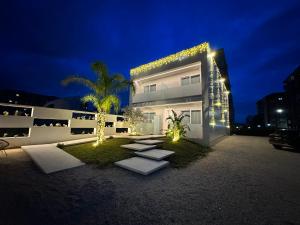 a house with lights on the side of it at night at Eich Business Accommodation in Santa Maria Capua Vetere
