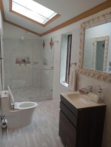 a bathroom with a tub and a toilet and a sink at villa saturia in Ráquira