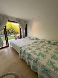 เตียงในห้องที่ Taiba Beach Resort Casa com piscina