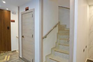 a staircase in a house with a glass door at HOTEL W Santa Marta in Santa Marta