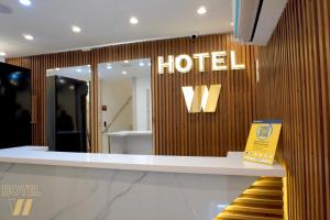 a hotel sign on the wall of a store at HOTEL W Santa Marta in Santa Marta