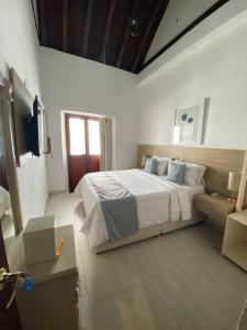 a bedroom with a bed and a television in it at Hotel Casa Agustina in Cartagena de Indias