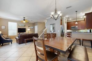 a dining room and living room with a dining table at Villages of Crystal Beach: Serenity in Destin