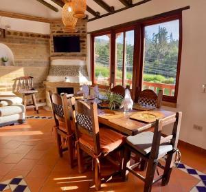 a dining room with a wooden table and chairs at VILLA CHARLOTTE 2 en colombia in Villa de Leyva