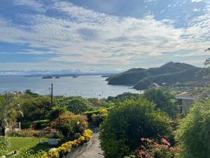 a view of the ocean from a garden at Bahia Pez Vela Resort in Ocotal