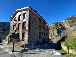 a building on the side of a mountain at La Mola de Prats Canillo in Meritxell