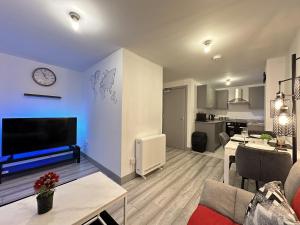 a living room with a couch and a dining room at Lilypad Suite - BHX Airport, NEC & HS2 in Solihull