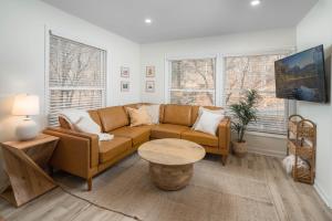 a living room with a couch and a table at Sunflower Suite at The Wanderer in Boone