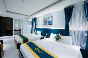 Postel nebo postele na pokoji v ubytování Gia An Hotel