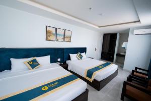 Postel nebo postele na pokoji v ubytování Gia An Hotel