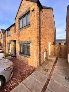 a brick house with a car parked in front of it at En-suite Room with Independent Entrance. in Edinburgh