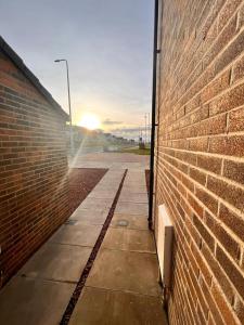 a brick wall with the sun setting behind it at En-suite Room with Independent Entrance. in Edinburgh