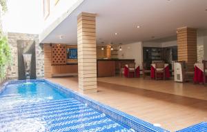 a swimming pool in the middle of a house at Hotel León Dorado in Bucaramanga