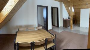 a dining room with a wooden table and chairs at Willa Rembisz in Łapsze Niżne