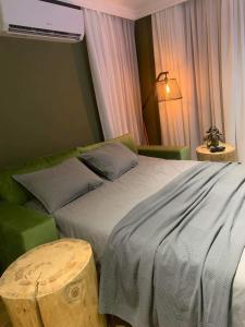 a bedroom with a large bed and a table at Luxury Green Apartment - up to 4 people in Bansko