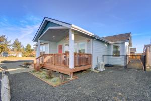 a house with a large deck on the front of it at Pet-Friendly Retreat with Game Room - Walk to Beach! in Ocean Shores