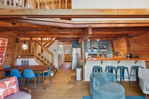 a kitchen and living room with a table and chairs at Charming Strawberry Cabin with Private Deck in Strawberry
